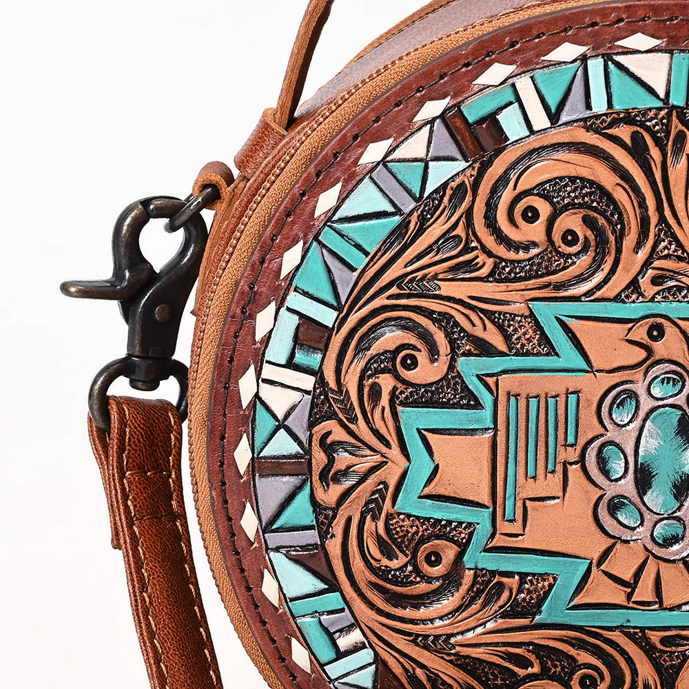 Round leather bag with intricate tribal design on a white background