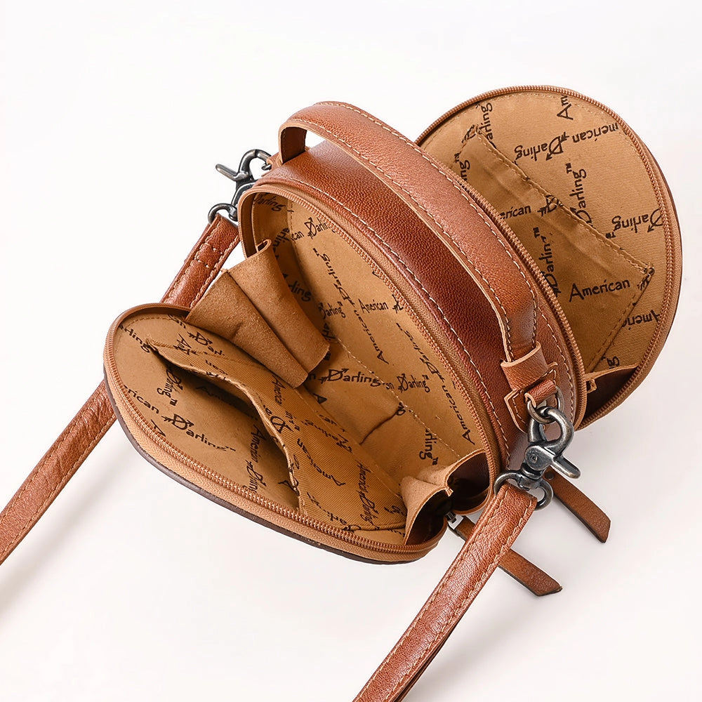 Interior of brown leather handbag with script pattern on a white background