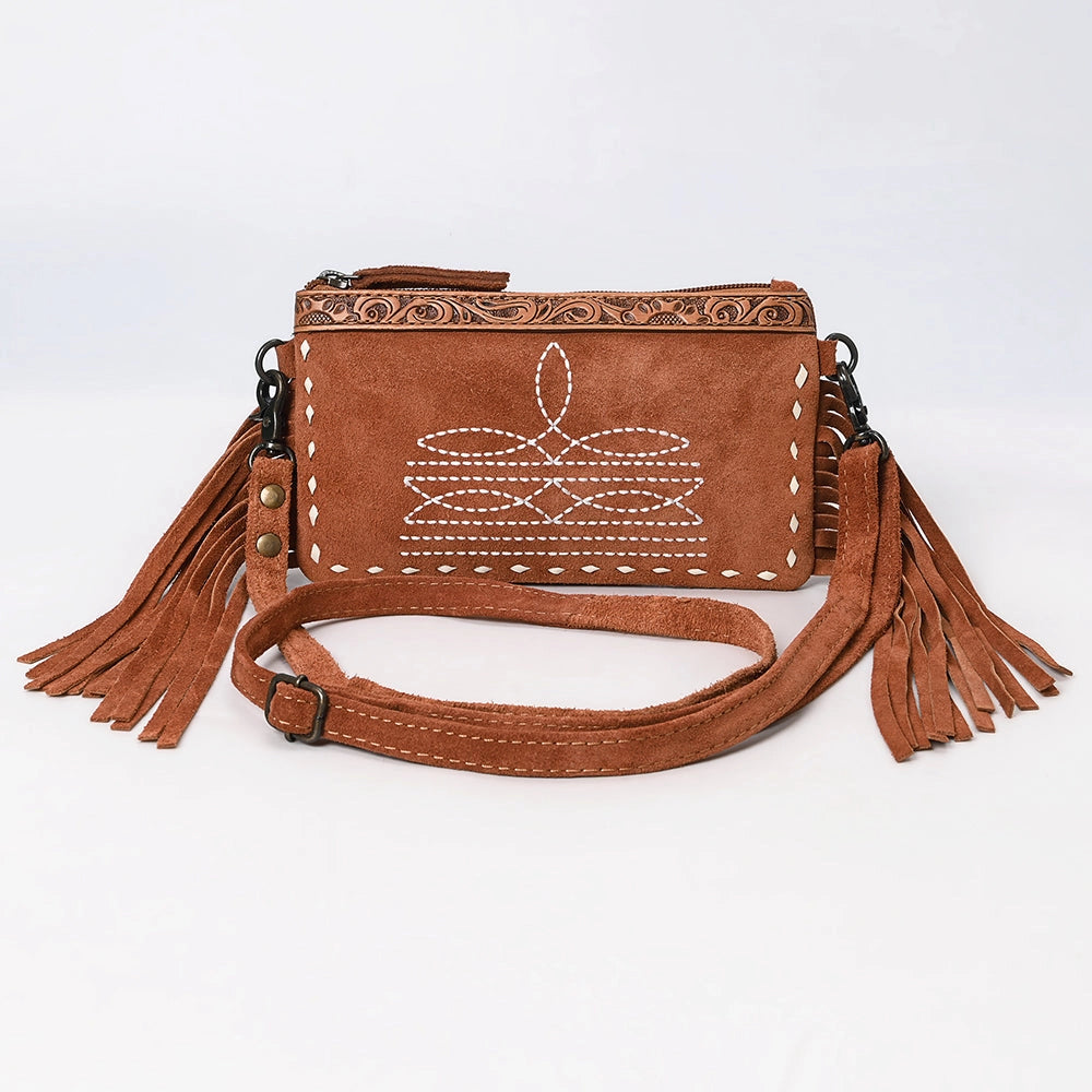 Brown leather handbag with tassels on a white background