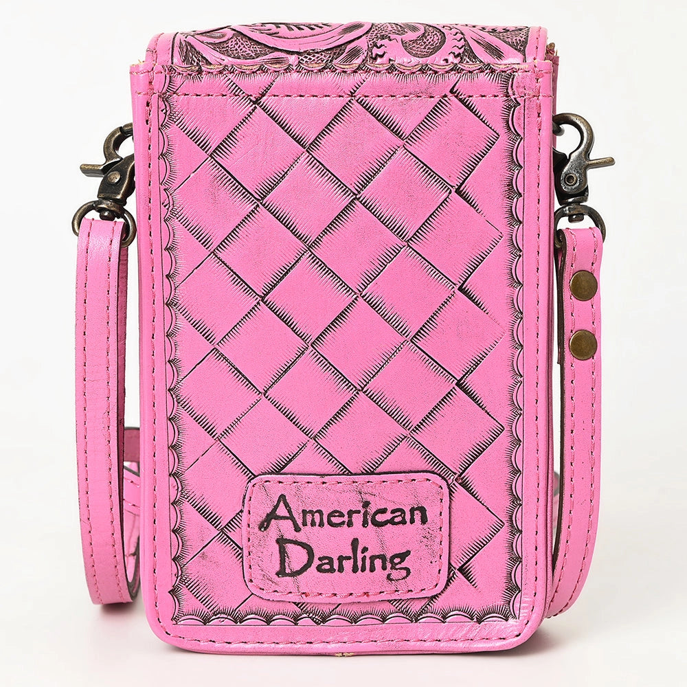 Reverse of a bright pink faux leather crossbody phone bag with a quilted diamond pattern, scalloped edges, and a front patch reading 'American Darling'. The bag has a matching pink strap and dark metal hardware, shown against a plain white background.