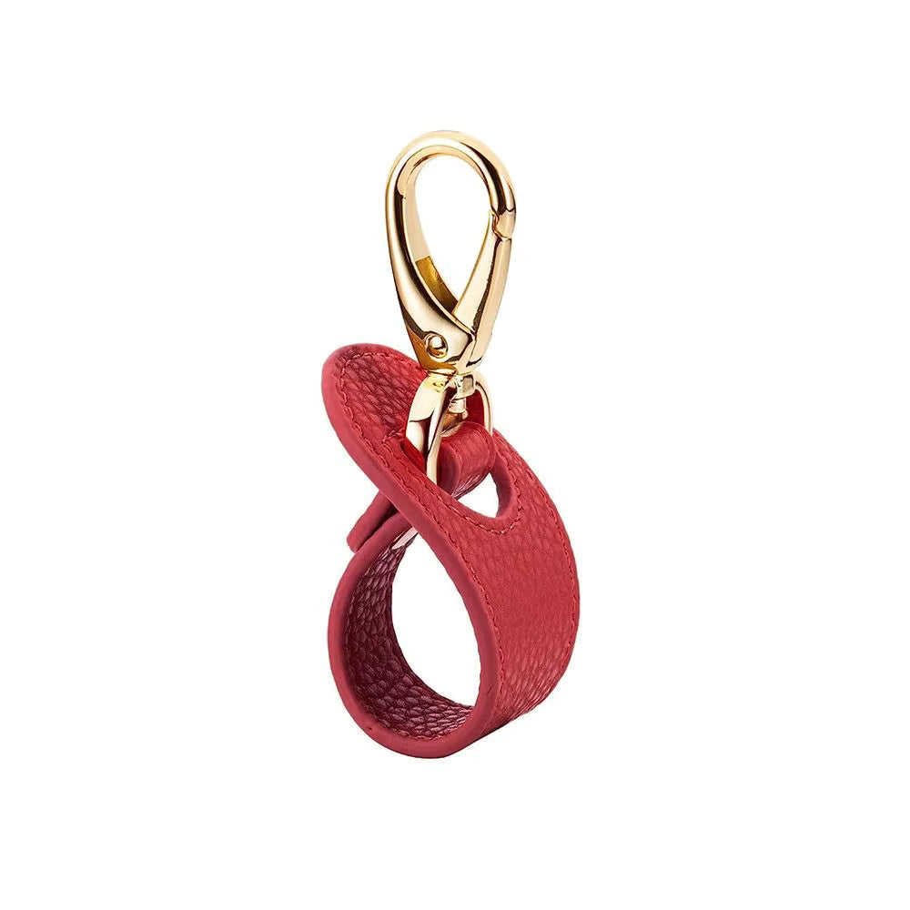 Red leather keychain or bag clip for baseball cap or trucker hat with gold clasp on a white background