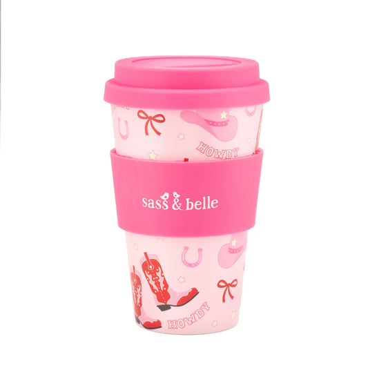 Pink travel mug with 'sass & belle' branding on a white background