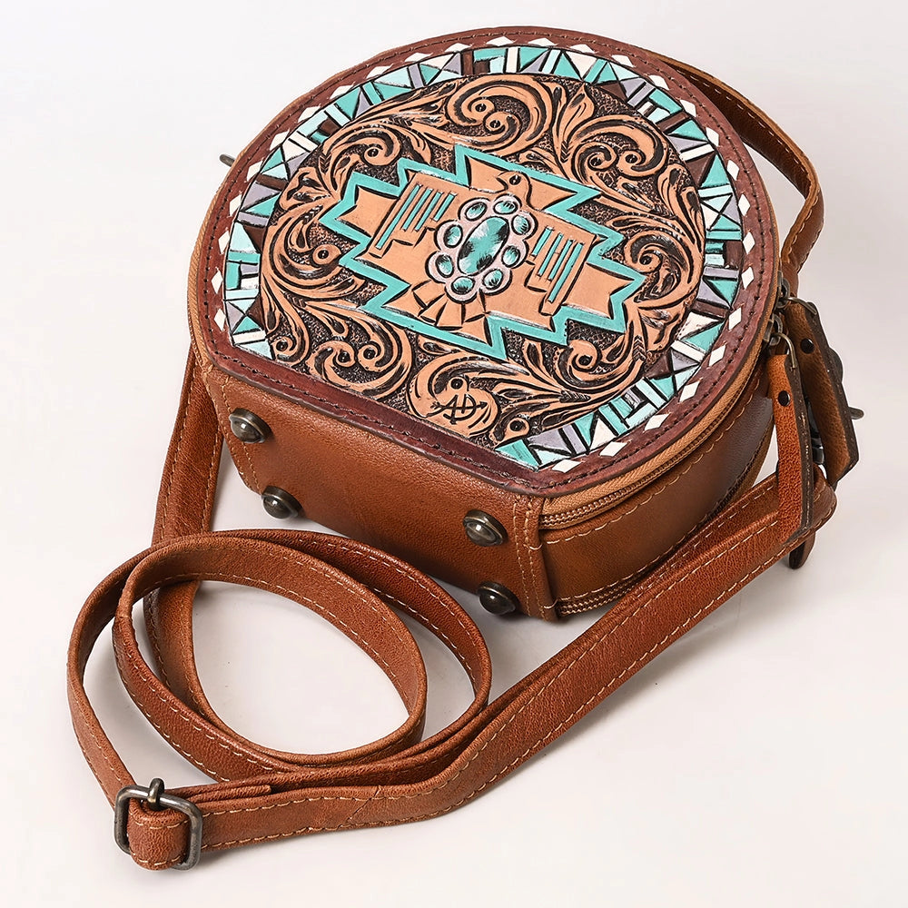 Brown leather crossbody bag with intricate turquoise and brown pattern on a white background