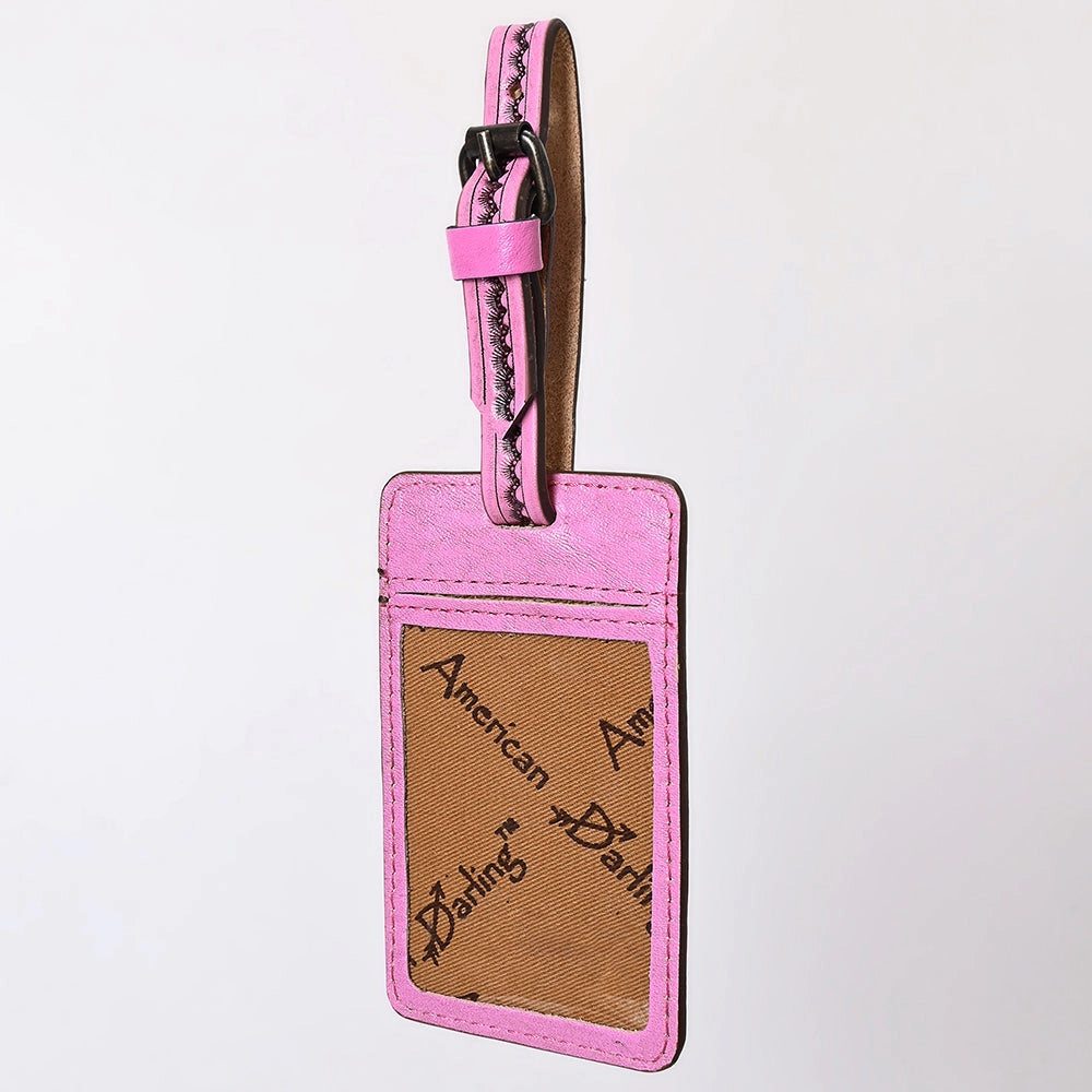 Reverse of pink luggage tag on a light gray background
