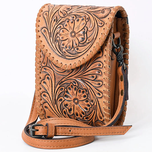 A tan leather crossbody bag with intricate floral tooling and braided leather trim, featuring a matching adjustable shoulder strap and black hardware, shown on a white background.