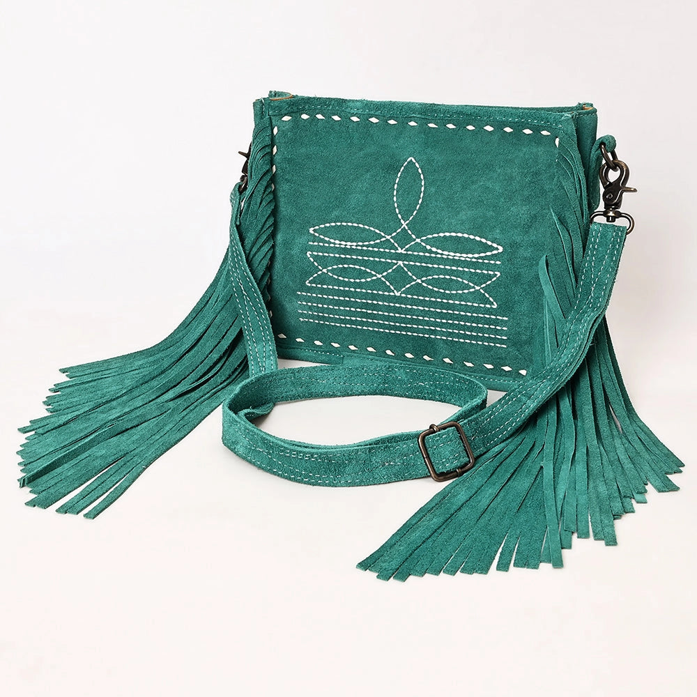 Teal suede handbag with fringe details on a white background
