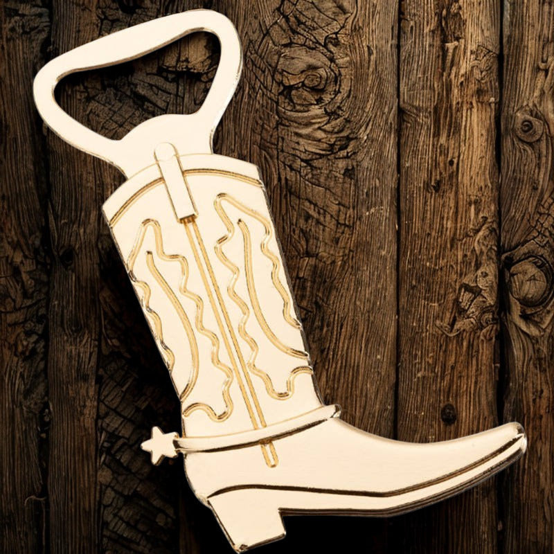 Cowboy boot bottle opener with gold detailing on a wooden background