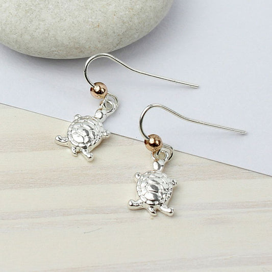 Silver plated turtle dropper earrings.