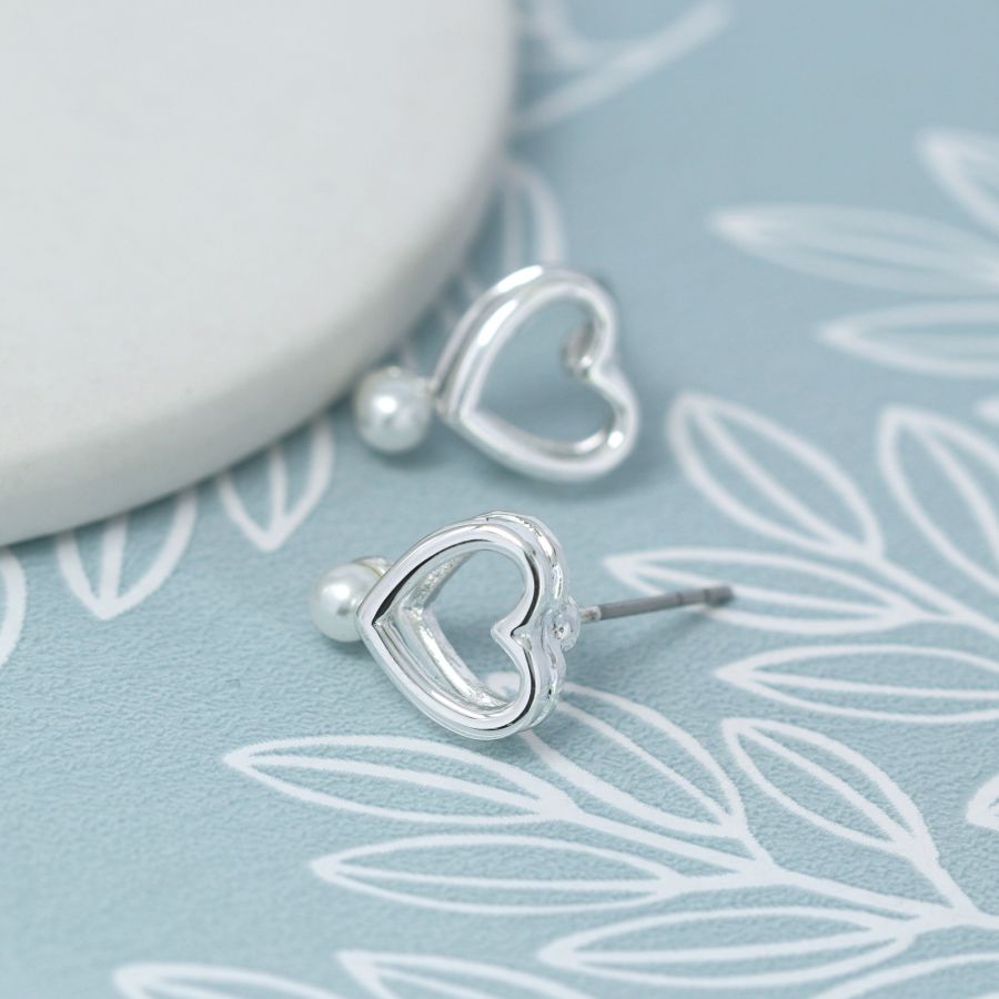 Double layer heart stud earrings with white faux pearls.