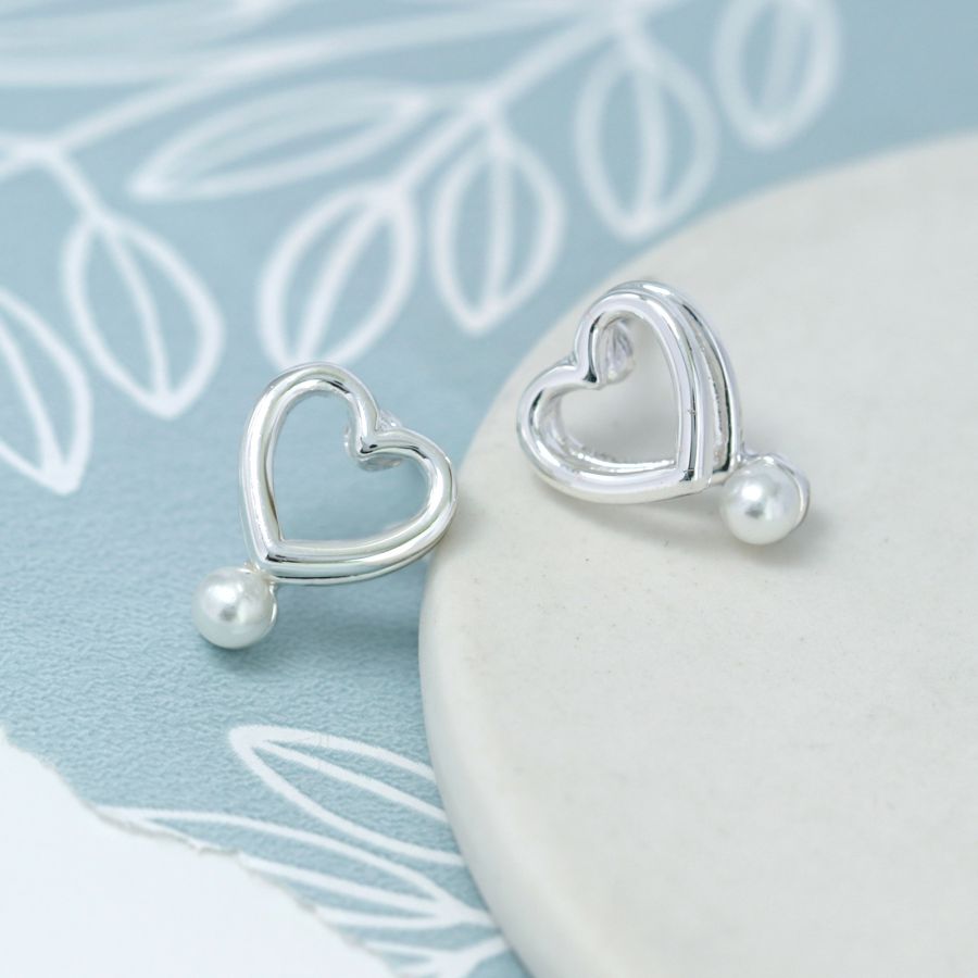 Double layer heart stud earrings with white faux pearls.