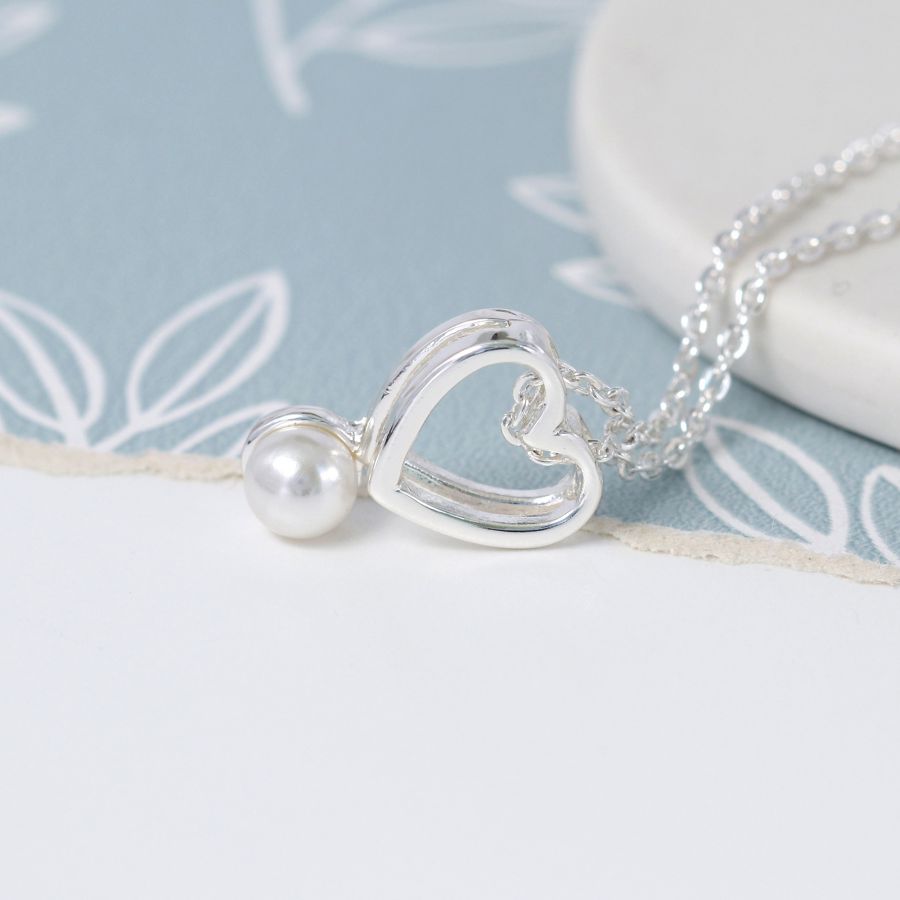 Fine chain silver plated necklace with a double layer open heart and a single white faux pearl