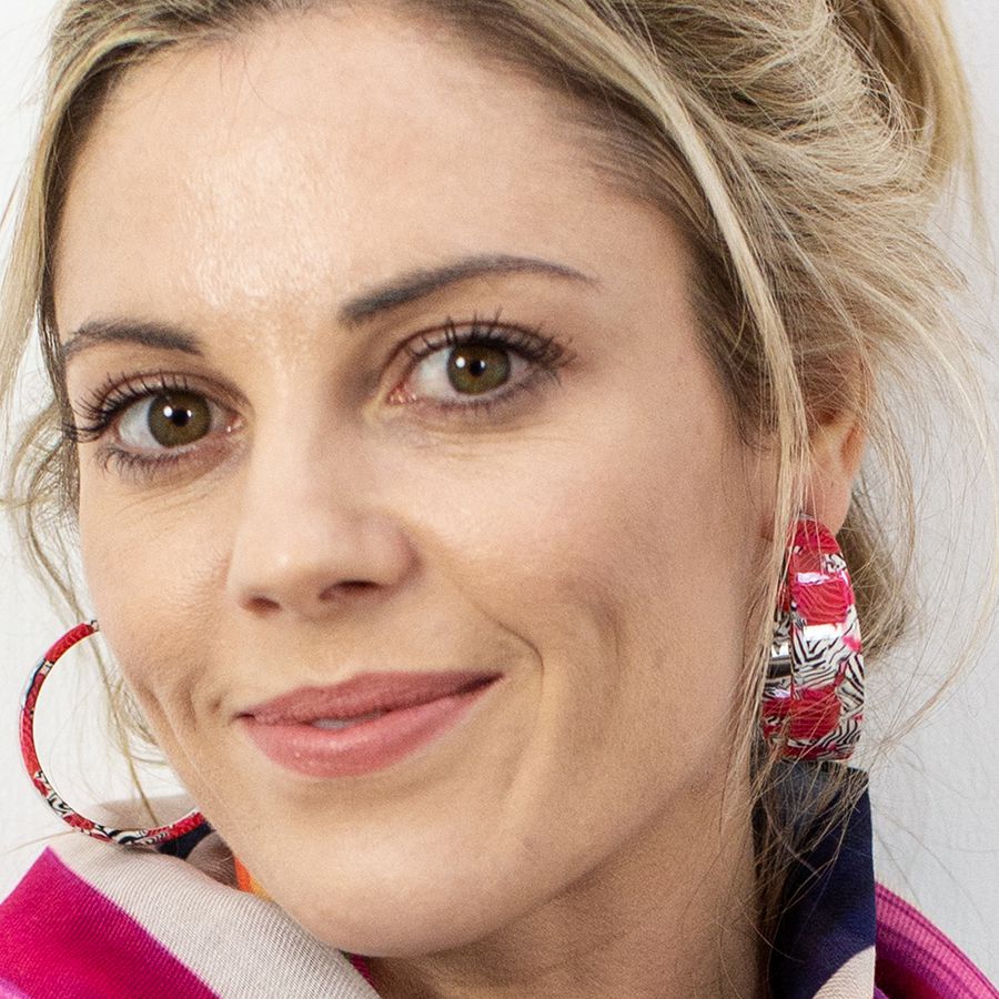 Model wearing Gorgeous acrylic lightweight open hoop earrings in a red and zebra stripe design