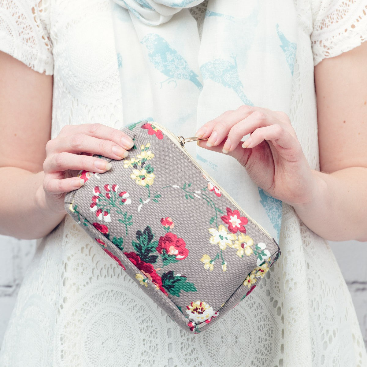 Vintage rose floral design make up bag on a grey background