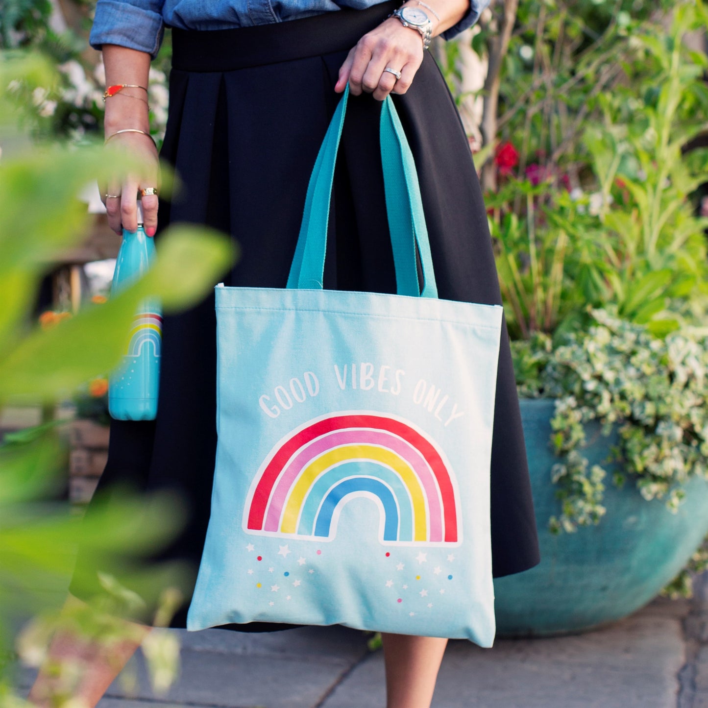 Gorgeous 'Good Vibes Only' slogan tote bag in sky blue, featuring a vibrant rainbow motif. 