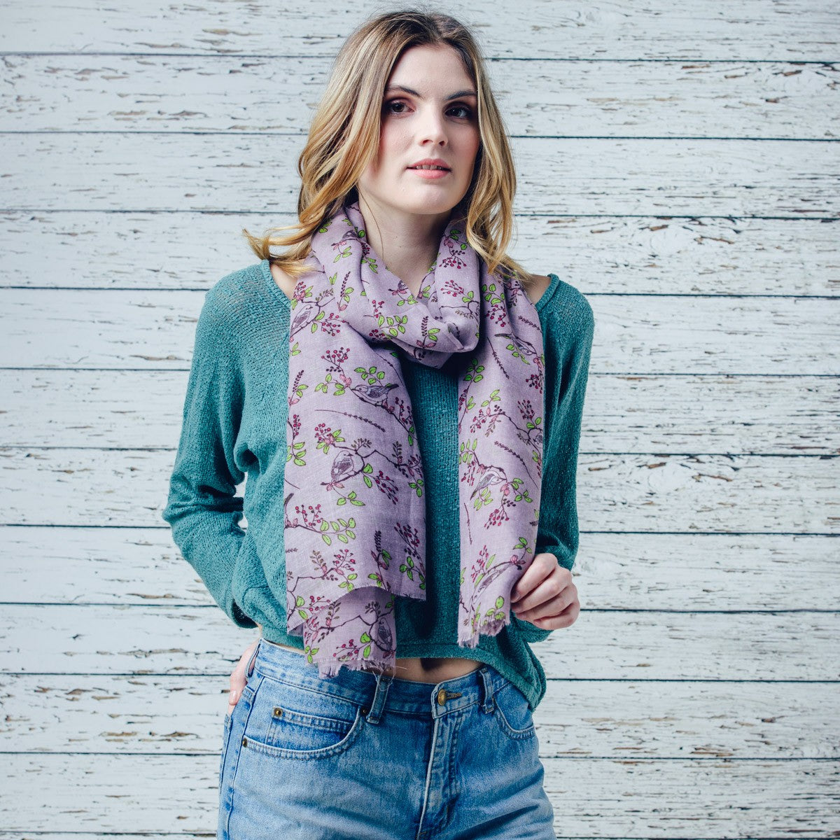A beautiful bird print design scarf on a solid coloured background and finished with a feathered edge