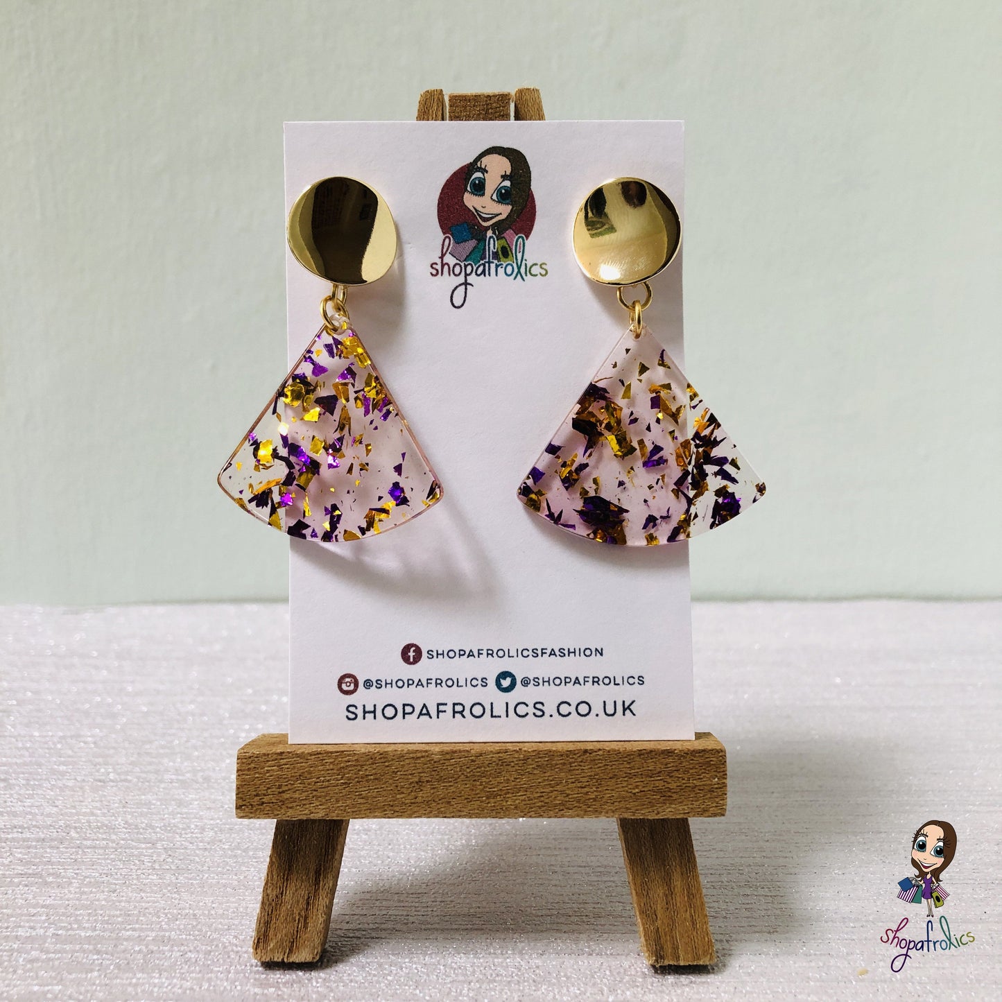 A gold and purple confetti effect, in a clear fan adds the statement to these drop earrings