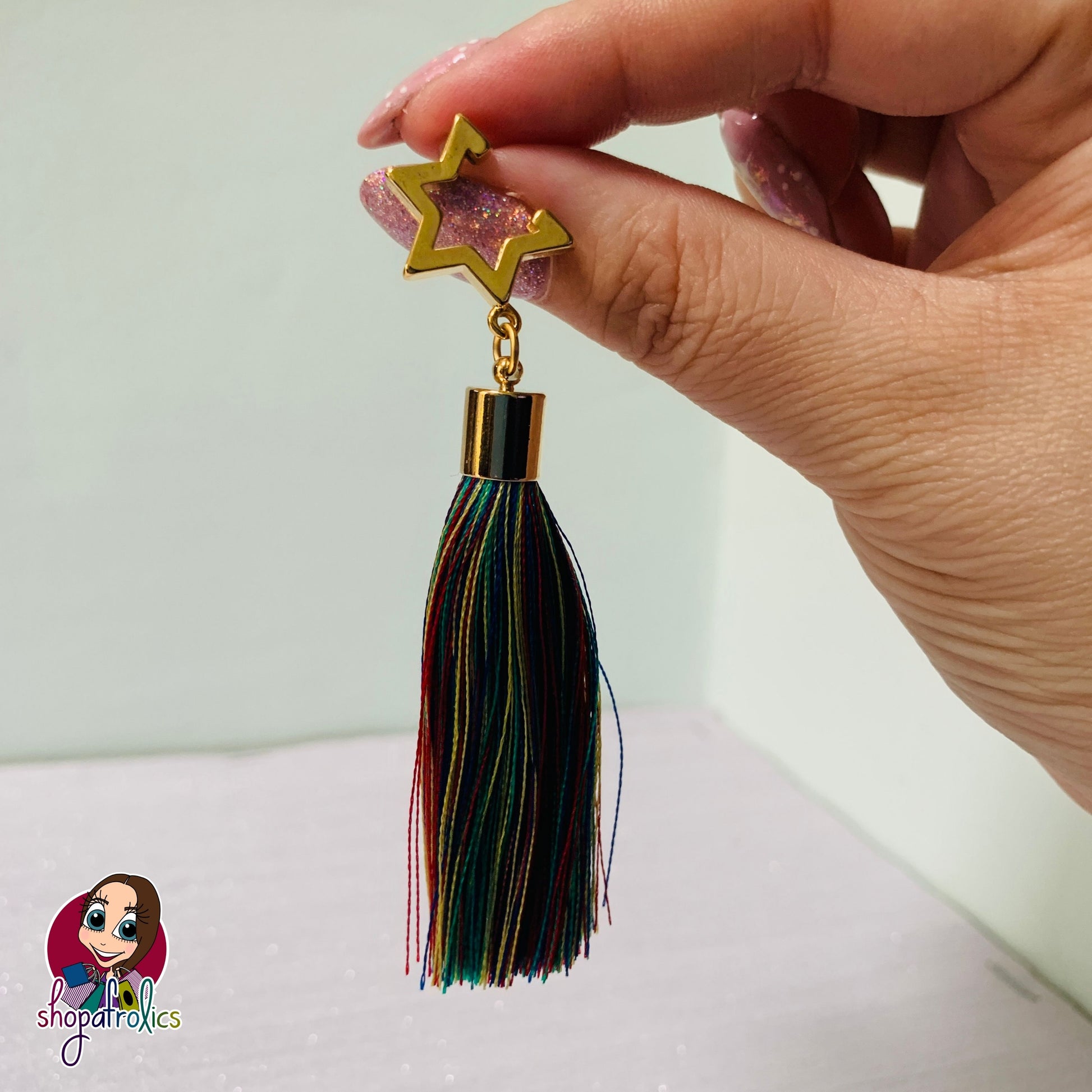 Close up of star and rainbow hassle earrings