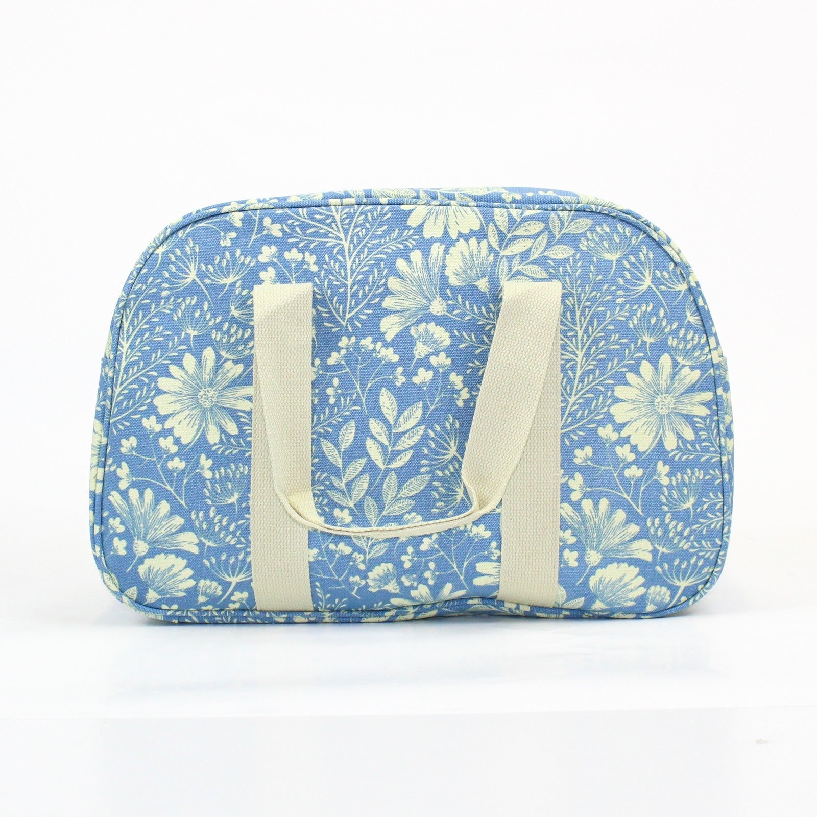 Pretty floral print weekend bag, on a light powder blue background.