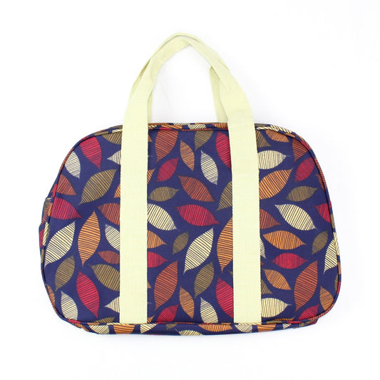 Autumn seasonal leaf print weekend bag, on a solid dark blue coloured background.