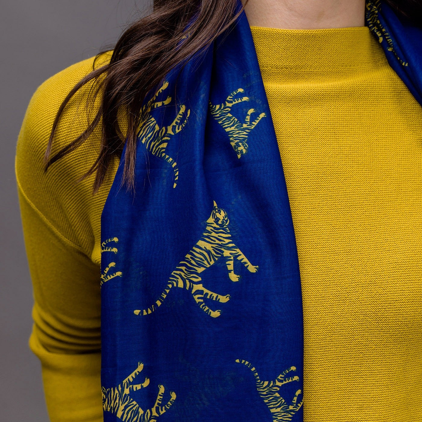 Tiger print on a royal blue background with a rolled edge. 