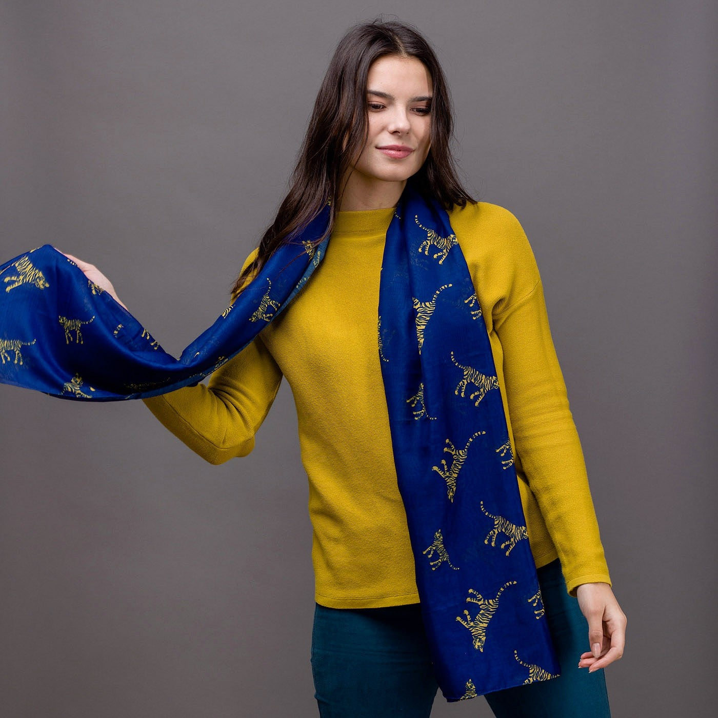 Tiger print on a royal blue background with a rolled edge. 