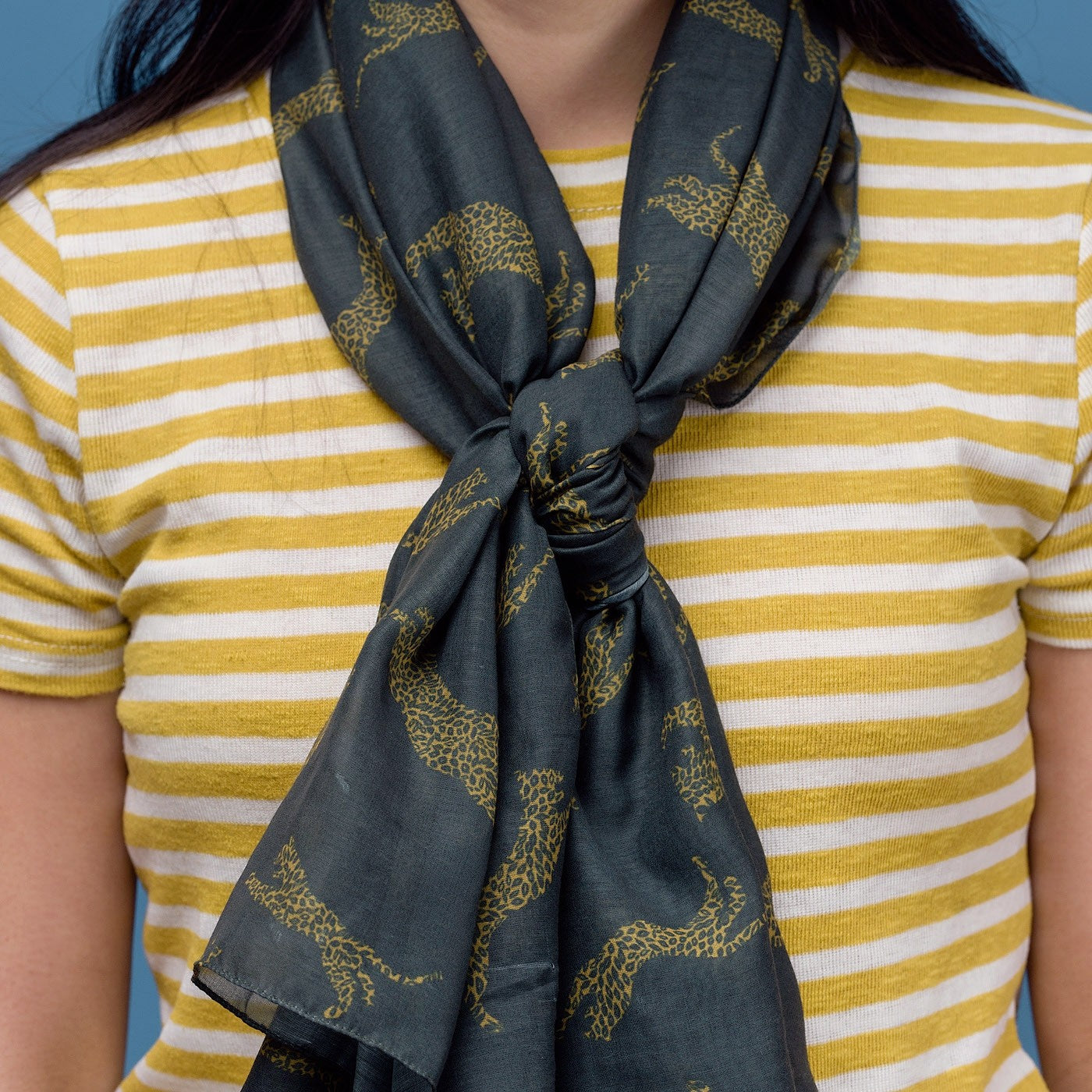 Leopard print on a dark grey background with a rolled edge. 