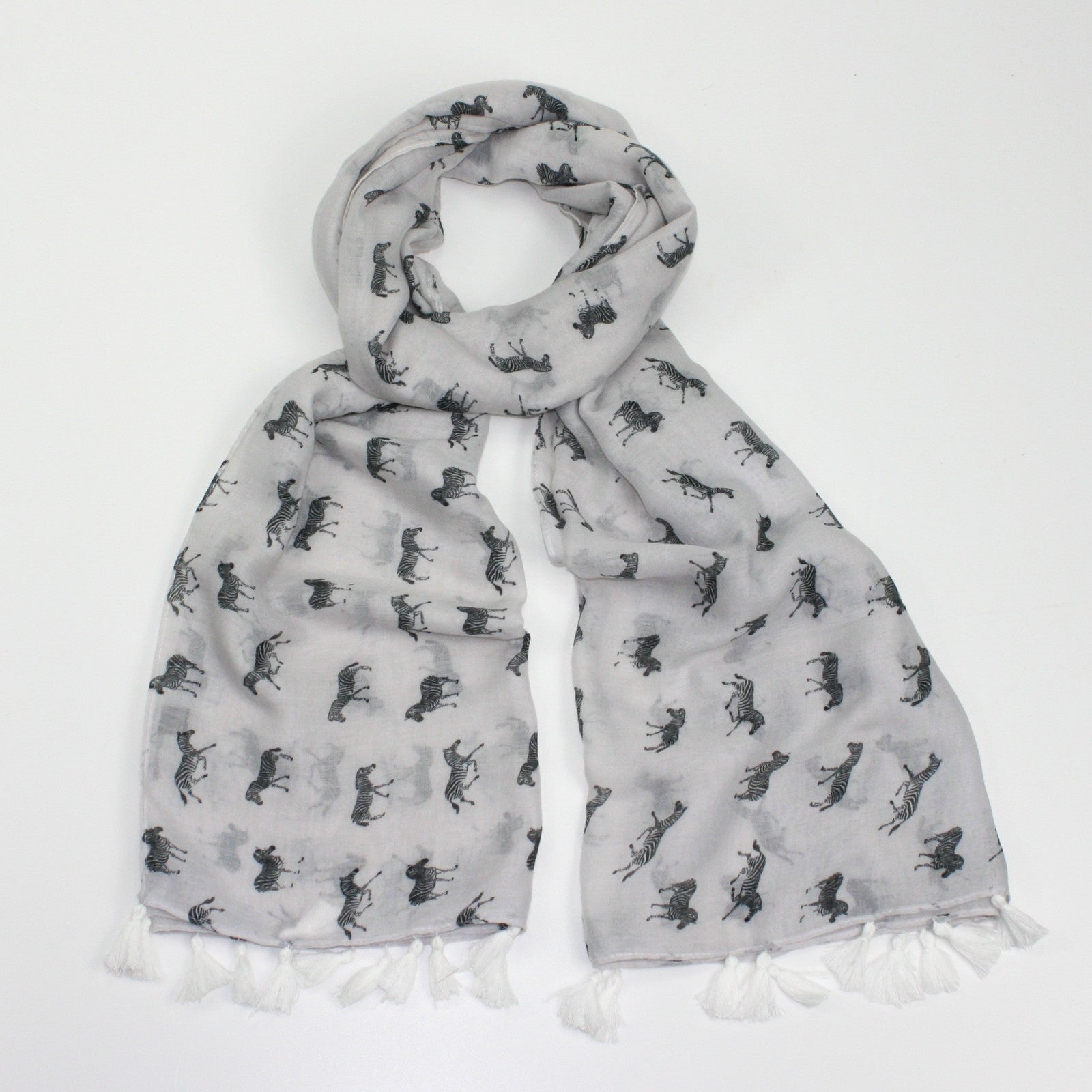 Zebra print on a white background with rolled and tassel edging