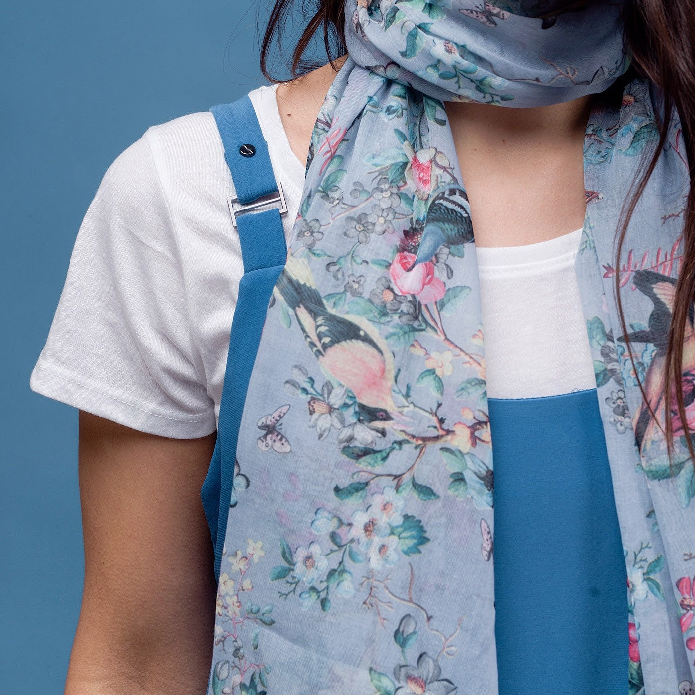 Delicate butterfly and bird print scarf in blue with rolled edge.