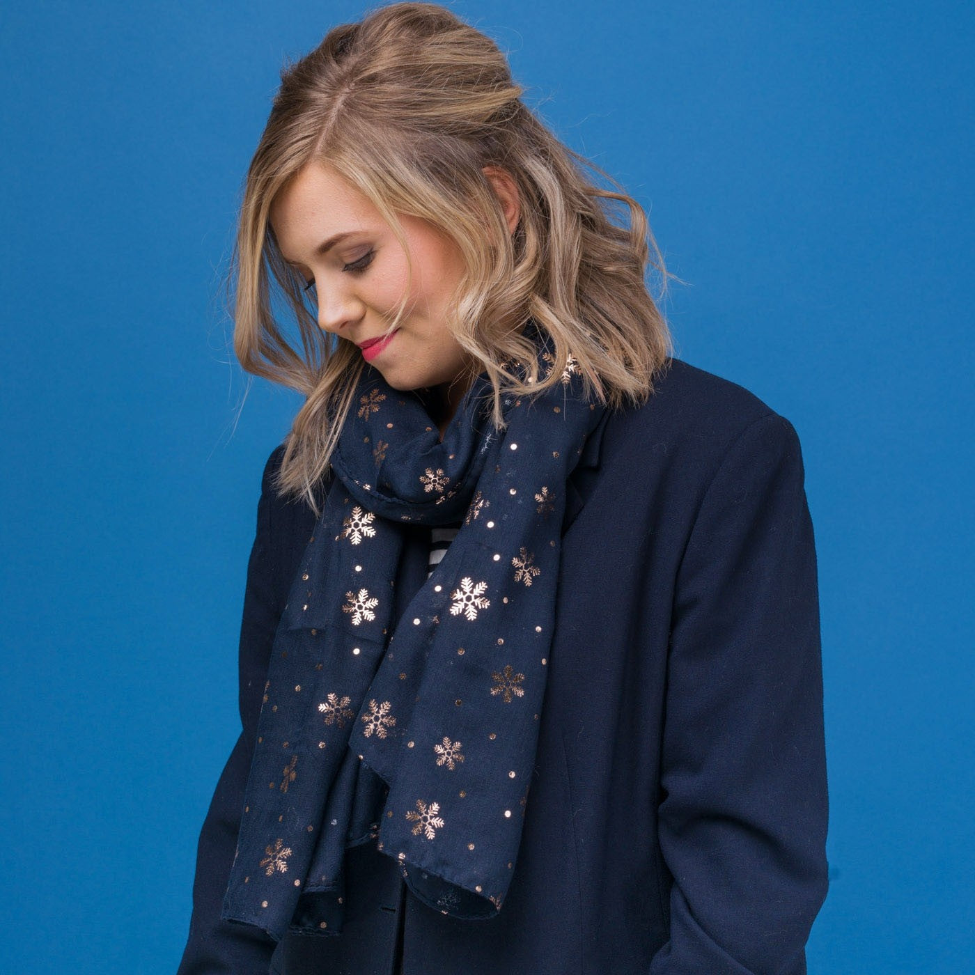 Delicate snowflake foil print navy blue scarf, finished with a rolled edge.